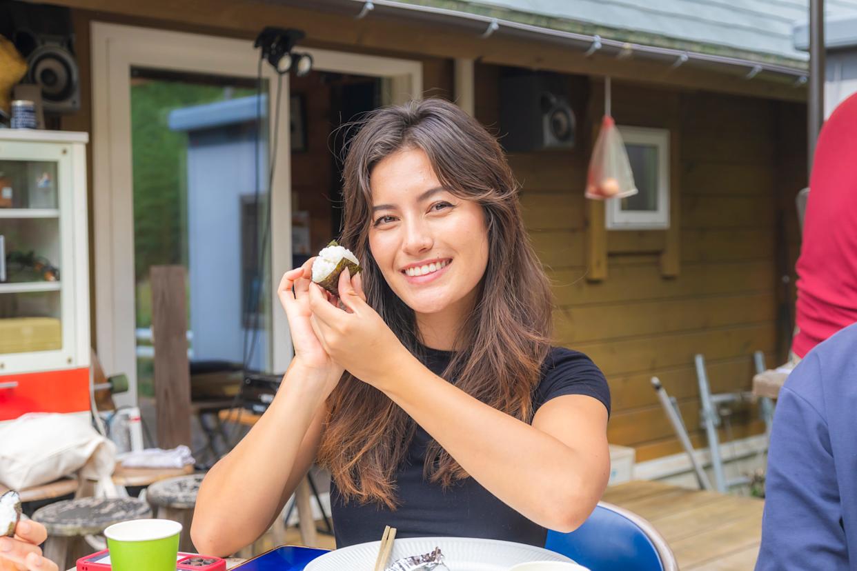 A woman holding rice and seaeed in Japan.