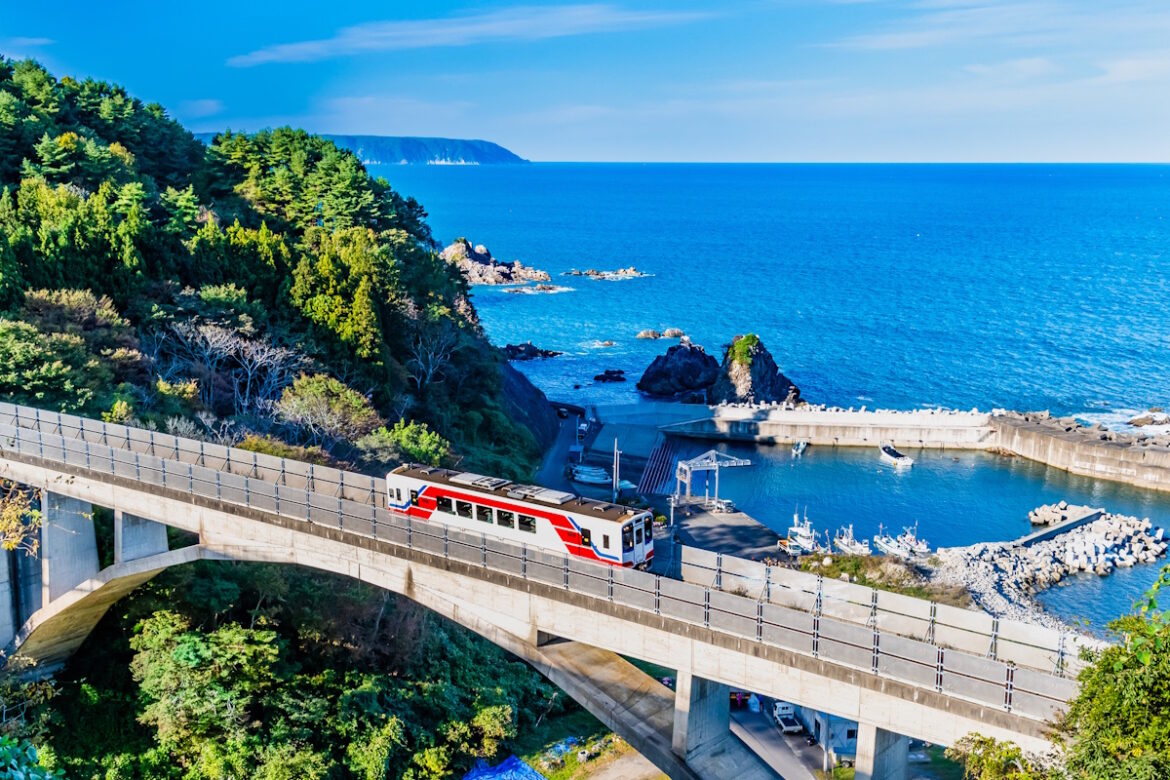 The Sanriku train against an ocean backdrop