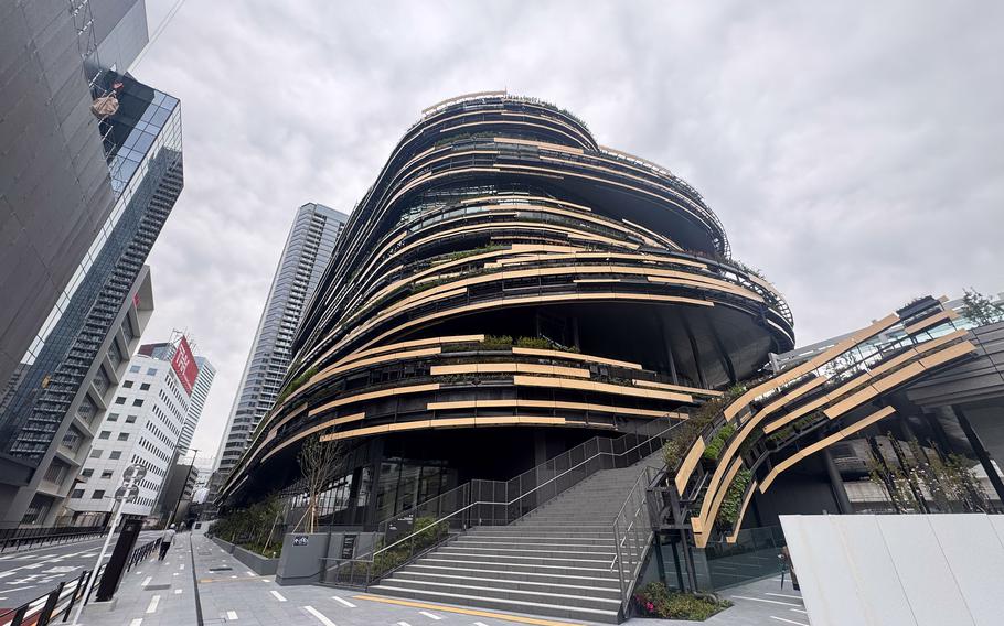 The exterior of a museum looks like it’s wrapped in black and yellow strips.