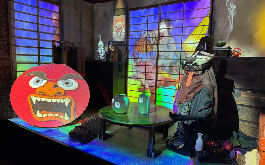 Objects are illuminated by projection lights in a museum display.