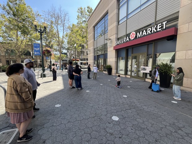 Customers await the opening of Sakura Market at the corner of South First Street and the Paseo de San Antonio in downtown San Jose, seen on June 24, 2026.(George Avalos/Bay Area News Group)