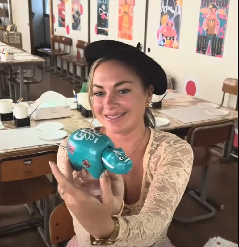 Painting an Akabeko sculpture in Fukushima Japan