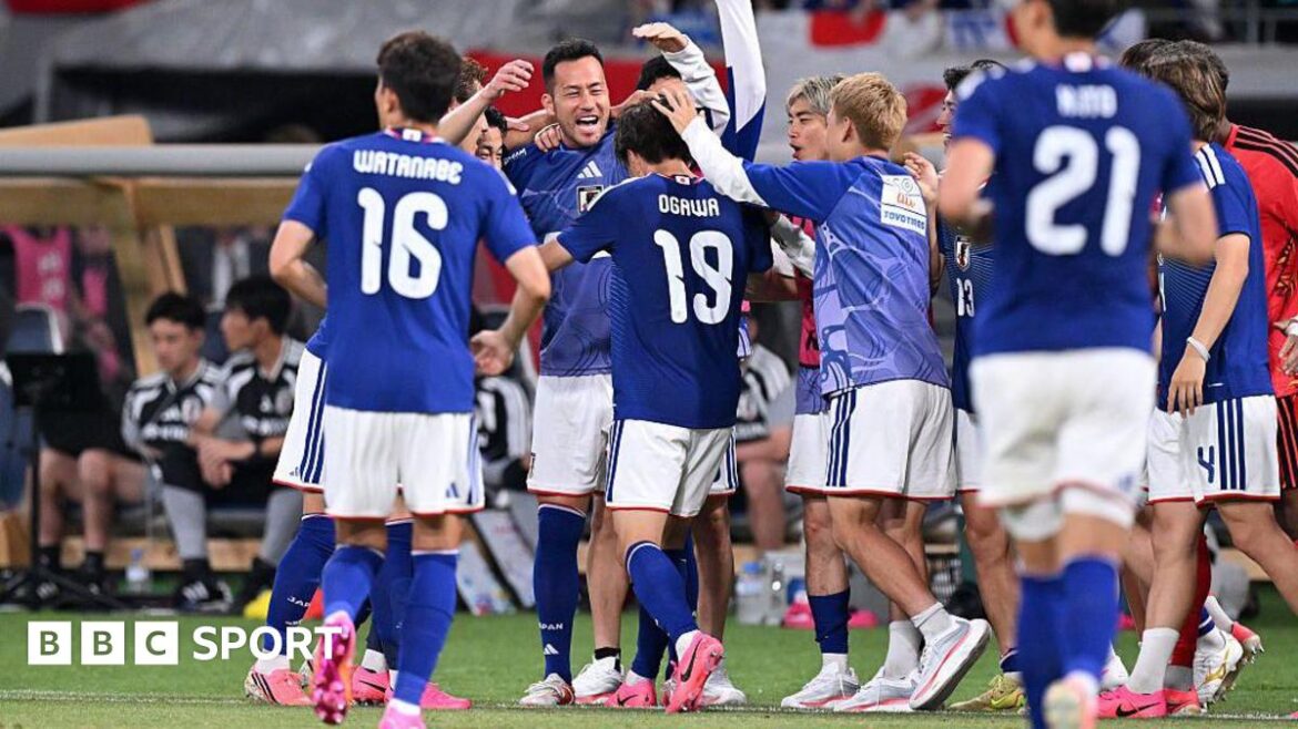 Japan players, in blue, celebrate a goal