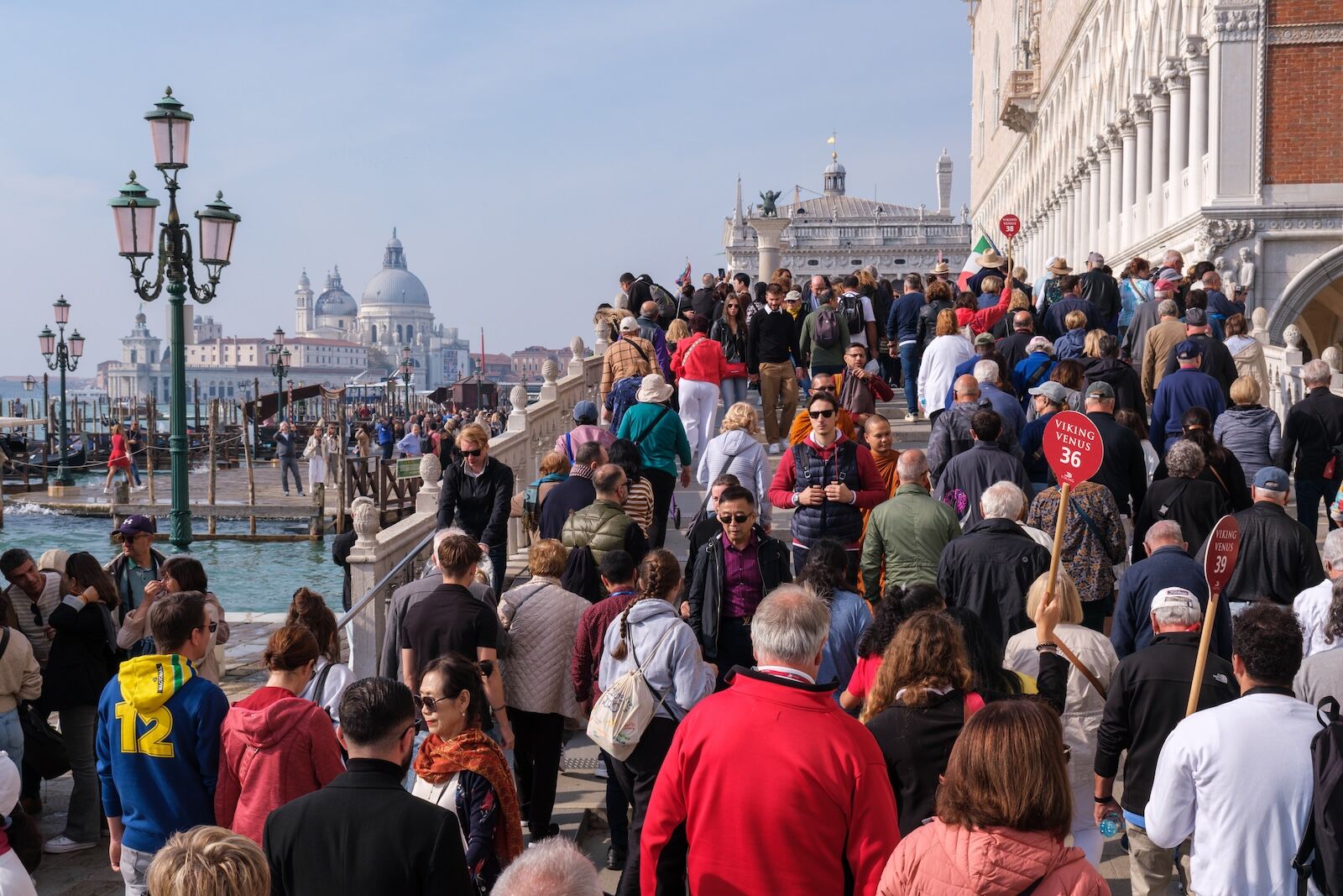 tourists on steps in venice, italy