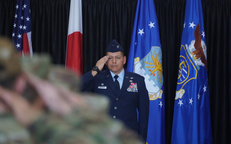 A military officer rendering a salute during a ceremony.