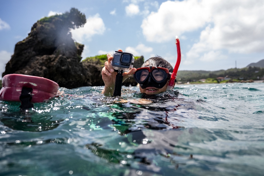 Shoichi Ikeno, head of local diving company Lagoon, snorkelling in a shallow area of the sea near Onna village, Okinawa Prefecture, July 9, 2026. — AFP pic