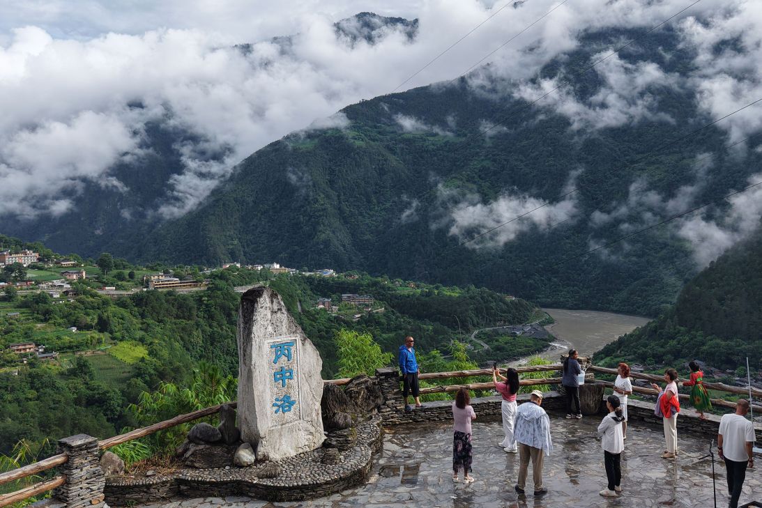 Tourists visit Bingzhongluo in China's Yunnan Province. High up in the hills, this area gets cool weather in the summer.
