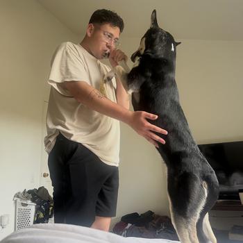 A Marine playing with his dog.