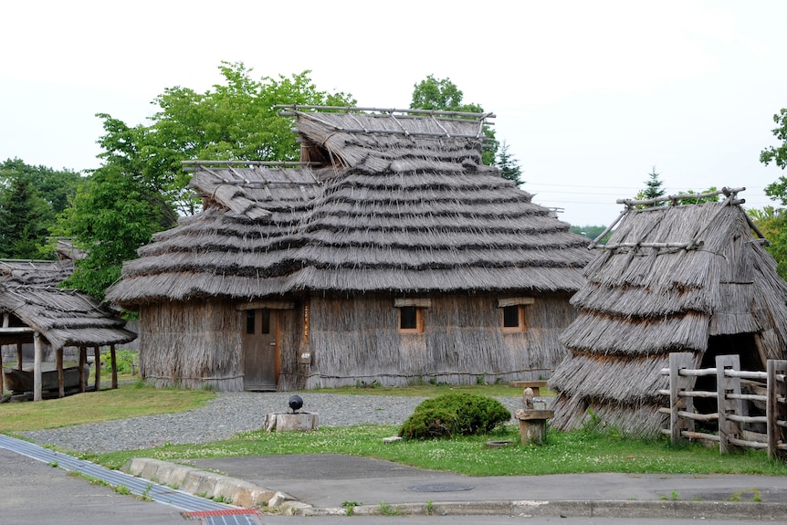A collection of wooden buildings, standing together.