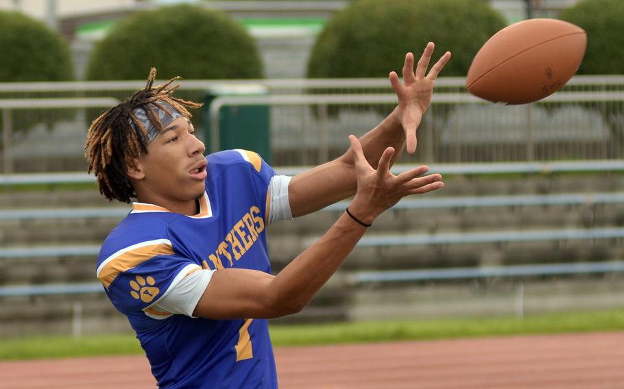 Jaydn Hooker looks in a pass during football practice.