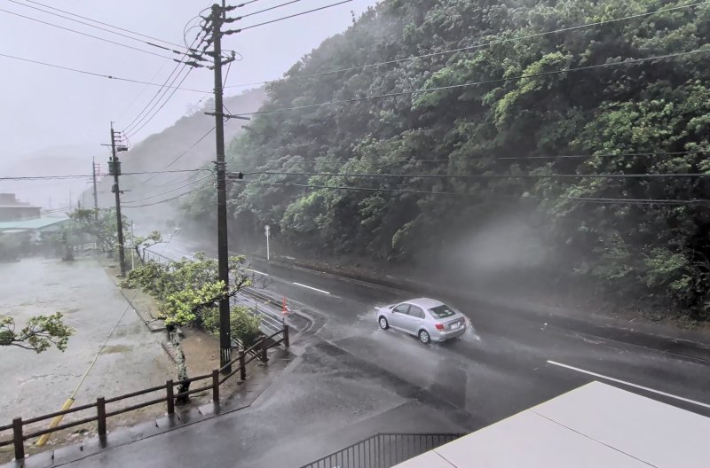 A car makes its way along a road being lashed by wind and rain as Typhoon Dolphin approaches in Amami, Kagoshima, Japan, on Friday. (Photo: @darider5/X via Reuters)