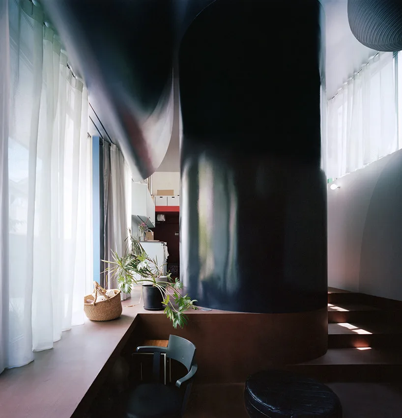 Tokyo Homes Transformed: ULTRA Studio's Radical Black Cylinder and Embrace of the Familiar Interior with symbolic decorative elements and artistic lighting centerpiece.