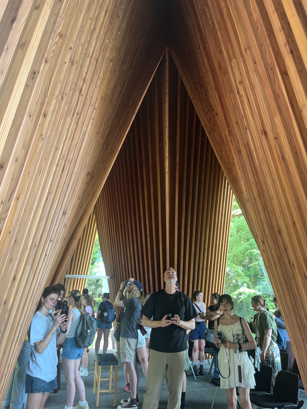 Rick Sommerfeld stands in a lobby under triangular wooden ceilings in Japan.