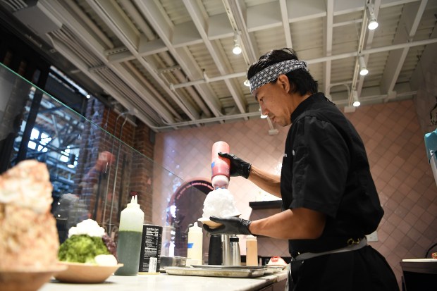 Kenta Kamo, owner of Temaki Den and newly-opened Kakigori Ken, adds syrup to a strawberry flavor of Japanese shaved ice served at Kakigori Ken in The Source in Denver on Thursday, July 25, 2024. (Photo by Zachary Spindler-Krage/The Denver Post)