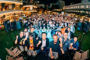 Large group photo of RAMEN TECH 2025 participants at an outdoor evening event in Fukuoka